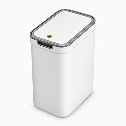 Mini poubelle salle de bain blanche fixée au mur au-dessus d'un lavabo