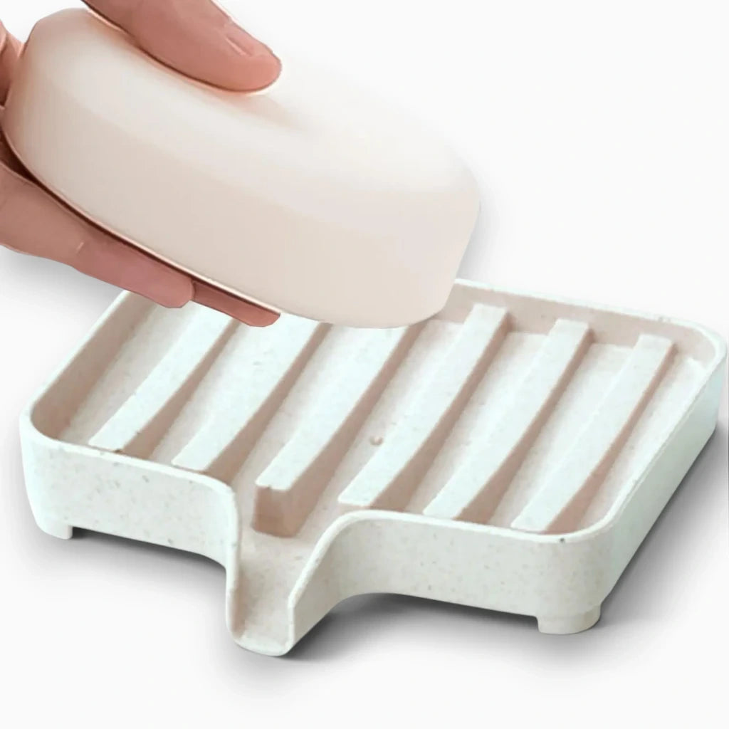 Support porte-savon pour barre de douche permettant l'écoulement de l'eau