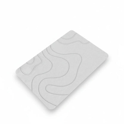 Tapis de bain design positionné près d'une baignoire pour sécurité maximale